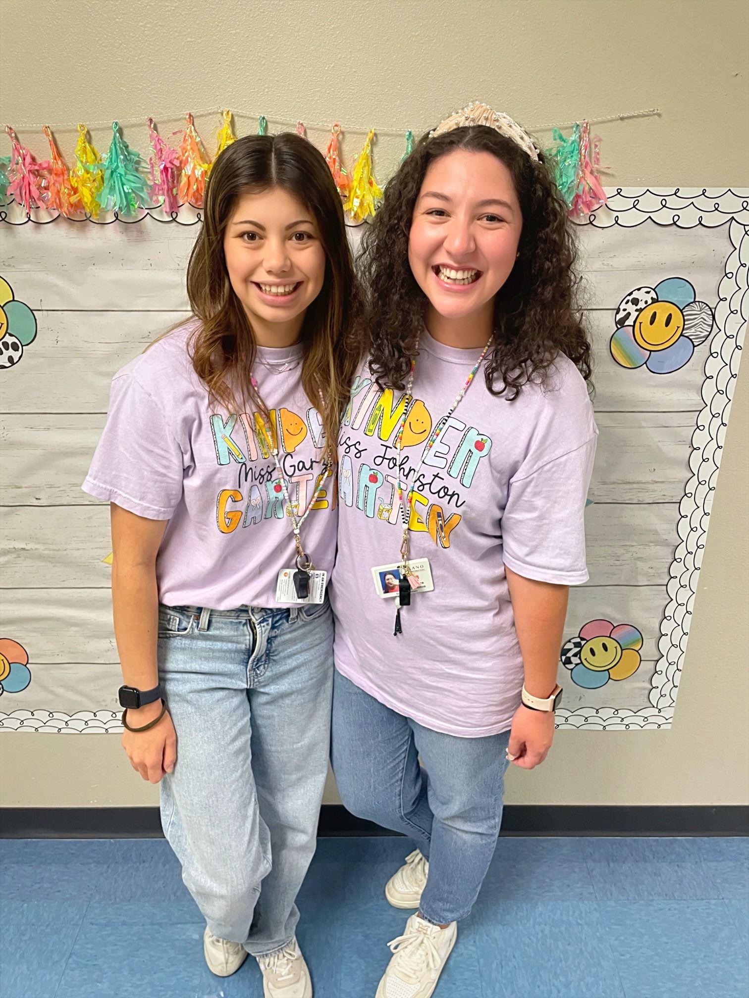 Ms. Garza and Ms. Johnston wearing their Skaggs team shirts and smiling